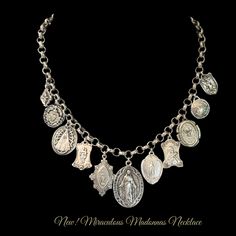 Our Miraculous Madonnas Charm Necklace is features 12 Vintage Reproduction charms with variety of Old World Madonnas and a Miraculous Medal focal point. Among the Madonnas are a vintage Saint Benedict cross, St. Therese the Little Flower, a Fleur de Lis and Saint Michael and the Dove of Peace also known as the Holy Spirit. These charms are made in New England by our silversmiths. Length: 18" and fully adjustable Materials: Sterling Silver clad bronze Vintage Pendant Necklaces With Dangling Charms, Vintage Sterling Silver Jewelry With Dangling Charms, Vintage Sterling Silver Charm Necklace, Vintage Sterling Silver Charm Necklaces For Jewelry Making, Vintage Medallion Necklaces With Charms, Vintage Silver Pendant Charm Necklaces, Vintage Medallion Charm Necklaces, Vintage Charms For Jewelry Making Necklaces, Handmade Vintage Charms For Jewelry Making