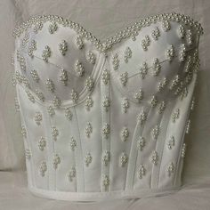 Looking for something truly special for your big day? This handmade satin corset top is a dreamy choice for brides who want to stand out. Adorned with hand-applied pearls and crafted with care, it's perfect for weddings, after-parties, or even a chic civil ceremony. The soft satin fabric feels luxurious on the skin, while the lace-up back gives you a snug and flattering fit. Whether you pair it with a flowing skirt for a classic bridal look or style it with tailored trousers for a modern vibe, t Madam Pompadour, Bridal Corset Top, Pearl Corset, Bjd Outfits, Bridal Crop Top, Bridal Bustier, Bead Bra, White Corset Dress, Sparkly Fashion