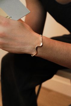 Embrace the power of the tides. Crafted from sterling silver, this curvy cuff wraps around your wrist in a sleek, wave-like motion, symbolizing the unstoppable force of momentum and reminding you to ride the waves of life with confidence and style. Whether you're exploring a coastal town or enjoying a casual brunch with friends, the Surging cuff is the perfect companion. Material: recycled sterling silver Weight: 10g Size: inclusive and adjustable, fits wrists between 5.5” and 7.2” Waves Of Life, Coastal Town, Casual Jewelry, Sterling Silver Cuff Bracelet, Sterling Silver Cuff, Silver Cuff Bracelet, Recycled Sterling Silver, Silver Cuff, Cuff Bracelet