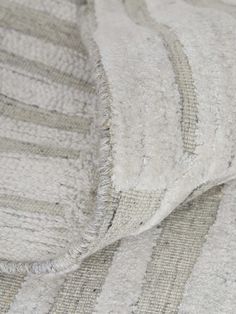 closeup of the texture of a white and grey striped blanket