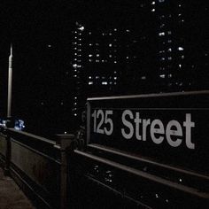 there is a street sign that says 123 street in the city at night with lights on