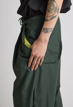 Sizes XS/S & M/LColor: Army GreenCargo StyleAdjustable HemAdjustable WaistSide PocketsBack Pockets100% NylonDry Clean OnlyBy The NKC Store Model is 195cm / 6'3" wearing size XS/S Green Relaxed Fit Techwear Pants, Summer Nylon Bottoms With Functional Pockets, Fitted Nylon Parachute Pants For Summer, Stretch Green Parachute Pants With Pockets, Green Stretch Parachute Pants With Pockets, Casual Green Nylon Parachute Pants, Utility Pants With Functional Pockets For Summer, Sporty Fitted Parachute Pants With Cargo Pockets, Green Nylon Cargo Pants, Athleisure Style