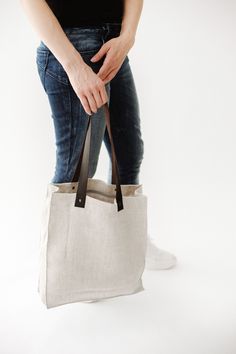 "● STRONG and DURABLE MATERIAL. Linen has a value of timelessness, so you can be sure that this organic tote bag is for a long use. ● STRONG HANDLES. Handles are with rivets which guarantees safe, secure and long-lasting use. ● INNER POCKET with ZIPPER. Your small things (keys, wallet etc.) will be safe while you're shopping or taking your things with you. ● CLASSIC COLORS. The natural linen color is perfect mostly with everything. ● ECOFRIENDLY. Linen fabrics meet OEKO-TEX 100 standards. ● SIMP Minimalist Canvas Tote Bag, Linen Tote Bag For Travel, Natural Canvas Tote Bag For Travel, Eco-friendly Canvas Bag With Leather Handles For Everyday Use, Eco-friendly Canvas Bag With Leather Handles, Natural Canvas Bag With Leather Handles, Natural Linen Tote Canvas Bag, Canvas Lined Tote Beach Bag, Everyday Natural Canvas Bag With Leather Handles