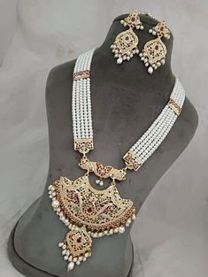 "Incredible timeless ensemble rendered into sophistication to compliment any occasion! Check our Gold Plated Hyderabadi Navratan / Multicolor Jadao Jadau Traditional Necklace set encrusted with multicolor /Navratan colored lab created semi precious  stones with layers of Hyderabadi pearls. Necklace is finished with pearl drops & cluster pearls. Matching earrings makes this set a masterpiece in itself. 👉🏻Approximate necklace length is 30-32\" long adjusted via drawstring. 👉🏻Matching statement Jadau Three Piece Necklace Bridal, White Round Beads Necklace For Diwali, White Round Beaded Necklaces For Diwali, White Beaded Necklace For Diwali Celebration, White Beaded Necklaces For Diwali Celebration, White Beaded Jewelry Sets For Festivals, Traditional White Beaded Necklace For Formal Occasions, Traditional White Beaded Formal Necklace, Traditional White Beaded Necklace For Formal Events