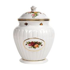 a white urn with flowers painted on the side and gold trimming around it