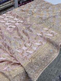 This Baby Pink Khaddi Georgette Hand Embroidery Saree is perfect for any wedding or traditional occasion. The easy drape and high-quality hand embroidery, along with moti, sequins, and diamonds work, will elevate your style and make you stand out from the crowd. Made of premium khaddi Georgette, it offers both comfort and elegance. Embroidered Dola Silk Sharara For Reception, Embroidered Chinon Sharara For Reception, Traditional Saree With Mirror Work For Reception, Unstitched Embroidered Sharara For Reception, Embroidered Saree Fabric With Mirror Work For Reception, Dola Silk Sharara With Resham Embroidery For Reception, Embroidered Sharara With Traditional Drape In Chinon, Embroidered Chinon Sharara With Traditional Drape, Reception Saree In Raw Silk With Mirror Work