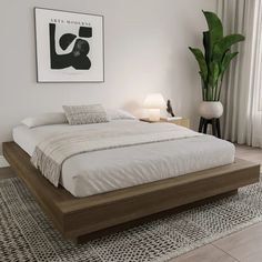 a bedroom with a bed, nightstands and plants in the corner on the wall