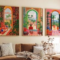 three paintings hang on the wall above a couch in a living room filled with furniture