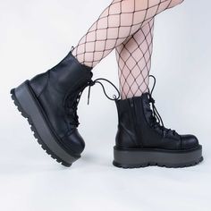 Combat boots with a twist! The SLACKER-55 boots are a versatile lace-up ankle boot with a comfortable 2-inch platform that are sure to become yer new fave staple. Vegan Black PU leather 2-inch platform Lace-up Inner zip Ankle length U.S women's sizing - refer to size chart for more info Punk Festival, Demonia Boots, Demonia Shoes, Goth Punk, Lace Up Ankle Boots, Black Matte, Creepers, Dr. Martens Boots, Alternative Fashion