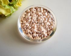 a bowl filled with cereal sitting on top of a white table next to yellow flowers