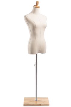 a white mannequin on a wooden stand