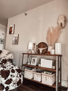 a bed room with a neatly made bed and some pictures on the wall above it