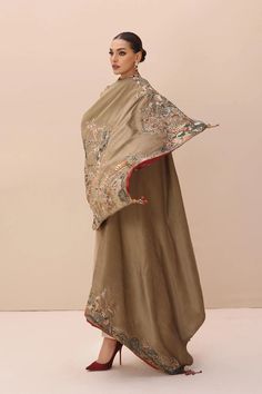 Gold Heavily Embroidered Pakistani Salwar Kameez with Enchanting Shawl a celebration of divine wonders through intricate embroidery techniques. This shawl is a tribute to the organic treasures found in the heart of nature. Its striking design is a canvas of delicate flora and fauna. To add a touch of wild elegance, it features a printed lining that hints at the mysteries of the forest. Adorned with hand-made tassels, lustrous pearls, Swarovski stones, sequins, and exquisite jewel pieces, this en Green Silk Anarkali Set With Embroidered Border, Festive Anarkali Set With Chikankari Embroidery, Eid Tussar Silk Kurta With Embroidered Border, Tussar Silk Kurta With Embroidered Border For Eid, Embroidered Tussar Silk Kurta For Diwali, Diwali Embroidered Tussar Silk Kurta, Eid Tussar Silk Anarkali Set With Resham Embroidery, Traditional Drape Kurta With Floral Embroidery For Eid, Floral Embroidered Kurta For Eid