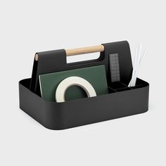 a black desk caddy with office supplies in it