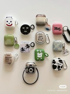 many different types of cell phones and key chains on a white surface with the words hello kitty printed on them