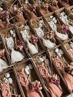 several boxes filled with different types of tassels and beads on top of each other