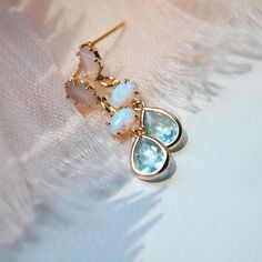 These something blue dainty earrings are created with tiny synthetic iridescent opal bezels secured to tiny faceted light green blue glass teardrops. The earring posts are created with gold plated over sterling silver and set with light pink glass. Whether searching for boho earrings as a birthday gift for a best friend or something special just for you, all of my jewelry arrives suitably gift wrapped ready for gift giving. Measurements: The dainty opal earrings hang approx. 1" long Metals: 14k Elegant Light Blue Hypoallergenic Earrings, Delicate Gemstone Drop Earrings, Dainty Gemstone Dangle Earrings, Dainty Blue Drop Earrings, Blue Drop Earrings As Gift For Her, Dainty Teardrop Earrings For Her, Dainty Teardrop Earrings As Gift For Her, Delicate Dangle Earrings With Birthstone, Light Blue Crystal Drop Earrings For Gift