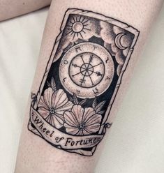 a woman's arm with a tattoo on it that says wheel of fortune and flowers