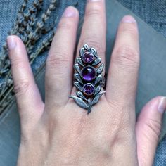 Amethyst silver ring, amethyst jewelry, lavender jewelry, handmade ring, artisan jewelry, crystal ring, purple gemstone ring, witchy jewelry Three amethyst gemstones lay in the middle of a lavender sprig. Each petal has been sawed by hand and attached to the stone bezels. I've also textured the petals and given the piece a soft satin finish. I've also oxidized the flower for contrast. The band of the ring is textured and wide, ensuring a comfortable fit. All components of the ring are hand fabri Handmade Amethyst Purple Rings, Purple Sterling Silver Crystal Open Ring, Handmade Amethyst Rings In Purple, Purple Sterling Silver Open Crystal Ring, Lavender Gemstone Crystal Ring As Gift, Lavender Crystal Gemstone Ring Gift, Purple Amethyst Crystal Ring With Natural Stones, Handmade Amethyst Crystal Ring In Purple, Amethyst Ring For Jewelry Making