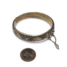 *Description: This is a beautiful Art Nouveau hinged silver bracelet with a gold wash from around the 1920s. It has European origins with stamps for silver and one difficult to read on the clasp. Photo is included. This silver bracelet with a gold wash was tested by me and tested for silver and minimum 10K gold wash or vermeil. The clasp and hinge are in great working order. If you are looking for a wonderful heirloom gift, this would be perfect. This bracelet would be a great addition to your v Formal Earrings, Art Nouveau Silver, Vintage Christmas Gifts, 1920s Vintage, Heirloom Gifts, Book Pieces, Gold Wash, Hinged Bracelet, Silver Filigree