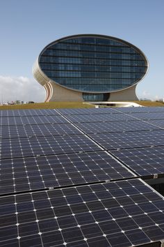 rows of solar panels in front of a building