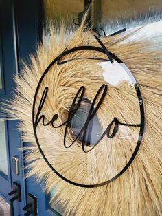 a sign that says hello hanging on the side of a door with some fur around it