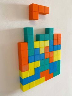 there are two blocks on the wall and one is made out of legos in different colors