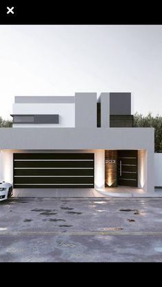 a car is parked in front of a modern house with lights on the garage door