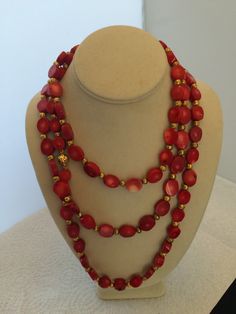 Red  Coral Necklace with Gold plated beads and clasp. N121-C  Length : 60 inches The Coral has been impregnated to preserve the quality of the stones.   Hand made by a local  artisan in the Miami,Fl.jewelry district.  Every stone, individual knotted.   Same day shipping   order by 1PM. eastern standard time.  History and Lore of the stone: Coral can be used to reconnect with nature and its variety of wonders. Coral also attracts love and prosperity, particularly red coral, which is a stone of passion. Creativity and optimism are also qualities that coral brings out. Emotionally, coral brings inner peace, strength, and understanding of purpose.  What does red coral do spiritually? Increased Confidence and Courage Elegant Multi-strand Red Coral Jewelry, Elegant Red Coral Beaded Necklace With Faceted Beads, Red Double Strand Beaded Necklace With Polished Beads, Elegant Red Coral Gemstone Beads, Elegant Red Coral Necklace With Large Beads, Red Double Strand Jewelry With Faceted Beads, Elegant Red Necklace With Gold Beads, Elegant Red Coral Beads For Jewelry Making, Vintage Red Gemstone Beads Jewelry