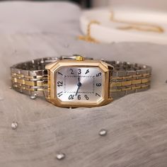 Enhance your style with this elegant women's gold and silver two-tone watch. Designed to offer both sophistication and practicality, this exquisite timepiece is the perfect accessory for any occasion. ✈All Orders Express Shipping Via UPS or FedEx 💎 Product Specifications: ➡ Case Diameter: 20mm x 30mm ➡ Material: Stainless stell ➡ Case Color: Gold ➡ Band Color: Silver and Gold ➡ Dial Shape: Rectangular  ➡ Strap Type: Metal Band ➡ Movement: Quartz ➡  Key Features: 💎 Stylish Two-Tone Design: The Rectangular Quartz Watch For Everyday Use, Everyday Rectangular Watches With Metal Dial, Timeless Rectangular Watch With Adjustable Fit, Timeless Adjustable Rectangular Watch, Classic Metal Watch Bands For Gifts, Classic Square Watch Accessories For Gifts, Watches With Bracelet Strap And Rectangular Dial, Vintage Rectangular Watch For Everyday, Watches With Adjustable Bracelet Strap And Rectangular Dial