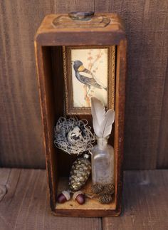 a small wooden box with a bird in it