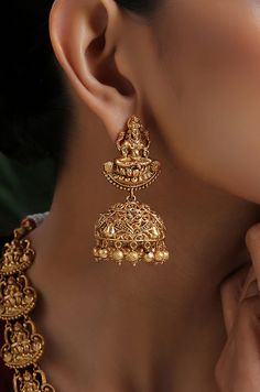 This opulent intricacy worked in geru gold plated silver alloy has its charm in its regal detailing. The monotonicity of gold is eased by adding the pretty pearls accentuating the charm of this temple work beauty. Necklace Closure - Adjustable Dori Earrings Closure - Push Back Style Tip - Style this with classic banarasi sarees, lehengas or indo western wear dresses. A perfect match with almost any traditional classic. This one comes straight off a nani inspired jewelery wardrobe and offers hint Festive Yellow Gold Pendant Jewelry, Yellow Gold Chandbali Temple Necklace As Gift, Gold Meenakari Pendant Jewelry, Yellow Gold Pendant Temple Necklace For Wedding, Yellow Gold Temple Necklace Pendant For Wedding, Gold Hallmarked Chandbali Temple Necklace, Yellow Gold Temple Necklace With Intricate Pendant, Gold Plated Tilla Temple Jewelry, Antique Gold Temple Necklace With Intricate Design As Gift