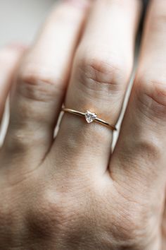 Introducing the newest addition to your stack! The Heart Diamond Stacker is sweet and playful with a dainty heart shaped diamond on a golden band. Wear your heart on your sleeve (or hand!) with this simple beauty. #ctwf Minimalist Heart Shaped Stackable Promise Rings, Minimalist Heart Cut Ring For Everyday, Dainty Heart Cut Ring For Everyday, Dainty Everyday Heart Cut Ring, Elegant Heart Cut Rings For Everyday, Elegant Everyday Heart Ring With Charm, Elegant Everyday Heart Cut Ring, Minimalist Everyday Heart Cut Rings, Minimalist Stackable Rings With Heart Charm For Wedding