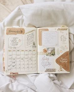 an open planner sitting on top of a bed