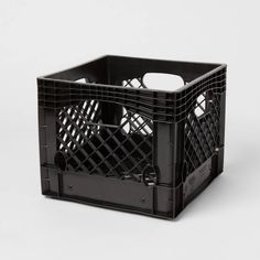 a black plastic crate sitting on top of a white table