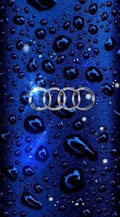 the front end of an audi car with water droplets on it