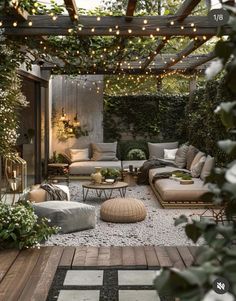 an outdoor living area with couches, tables and lights