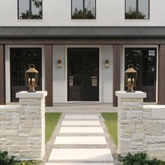 the front entrance to a house with two large doors