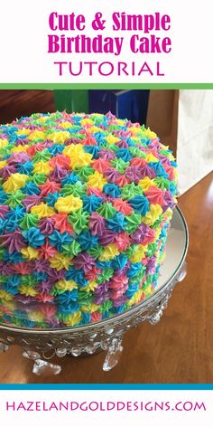 a multicolored cake sitting on top of a glass plate