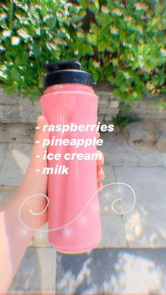 a person holding a pink cup with the words raspberries pineapple ice cream milk