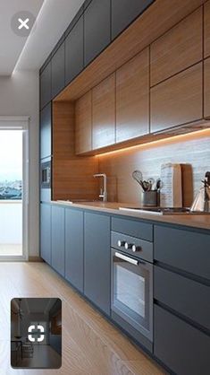 an image of a modern kitchen setting with wood cabinets and stainless steel appliances in the foreground