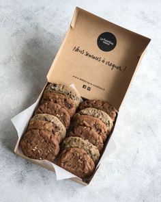 a box filled with chocolate chip cookies on top of a table