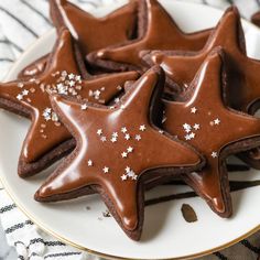 chocolate cookies decorated with white stars on a plate