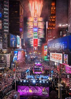 fireworks are lit up the night sky above times square during new year's eve