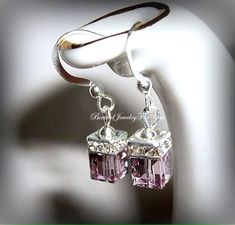 Light Amethyst Austrian crystals measure 6mm that are complimented with a crystal squaredelle to complete this lovely set of earrings. They hang from silver ear wires. You may choose different colors from the drop-down menu. These are perfect to gift to your bridesmaids, best friend, daughter and many more.... Check my shop for matching bracelets!  Click here to return to my shop's homepage: https://www.etsy.com/shop/beadedjewelryforyou?ref=simple-shop-header-name&listing_id=604235185 Mothers Birthstone Bracelet, Drop Earrings Wedding, Beautiful Baubles, Bridal Party Jewelry, Mothers Bracelet, Diamond Life, Wedding Earrings Drop, June Birthstone Jewelry, Bride Earrings