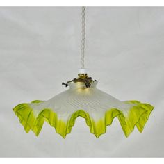 a yellow and white flower hanging from a ceiling light with chain attached to it's end