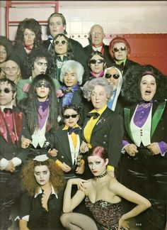 a group of people dressed in costumes posing for a photo