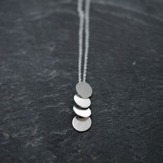 Sequins galore vertical multi silver disc necklace by Minicyn Minimalist Silver Long Drop Necklace, Modern Sterling Silver Long Drop Necklace, Modern Long Drop Sterling Silver Necklace, Modern Silver Dangle Necklaces, Modern Silver Lariat Necklace As Gift, Silver Minimalist Lariat Necklace With Pendant, Minimalist Silver Dangle Drop Necklace, Silver Sterling Silver Round Pendant Drop Necklace, Modern Silver Drop Necklaces