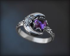 A beautiful, celestial ring to adorn your fingers. I melt down fine silver, then press into a gorgeous moon impression for the rose moon. A gemstone of your choice is set in a unique, ornate setting. The band features a beautiful scroll pattern, which has been brought out by oxidizing the entire ring. Crafted by hand from fine and sterling silver. This design is original to LE Jewelry Designs® Handcrafted by Lauren Elizabeth. Made in the USA. sold individually made-to-order sterling silver, gems Magical Crescent Sterling Silver Jewelry, Silver Crescent Gemstone Ring, Crescent Silver Gemstone Ring, Crescent Silver Ring With Gemstone, Magical Sun And Moon Design Ring, Mystical Cabochon Jewelry For Anniversary, Celestial Amethyst Moon Phase Jewelry, Celestial Moon Phase Amethyst Jewelry, Mystical Sun And Moon Design Jewelry For Wedding