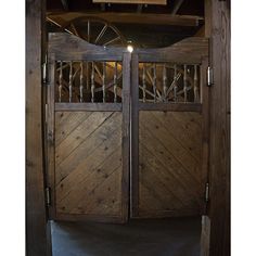 an open wooden gate with metal bars on it